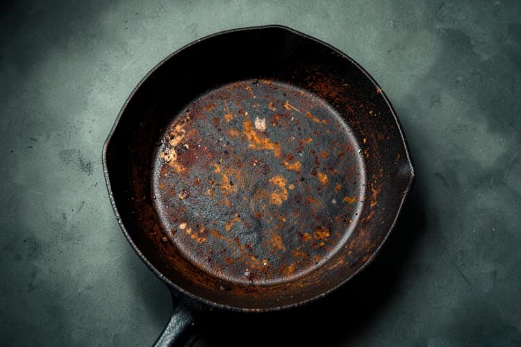 Uma panela de ferro fundido com ferrugem, mostrando os efeitos da falta de cura.